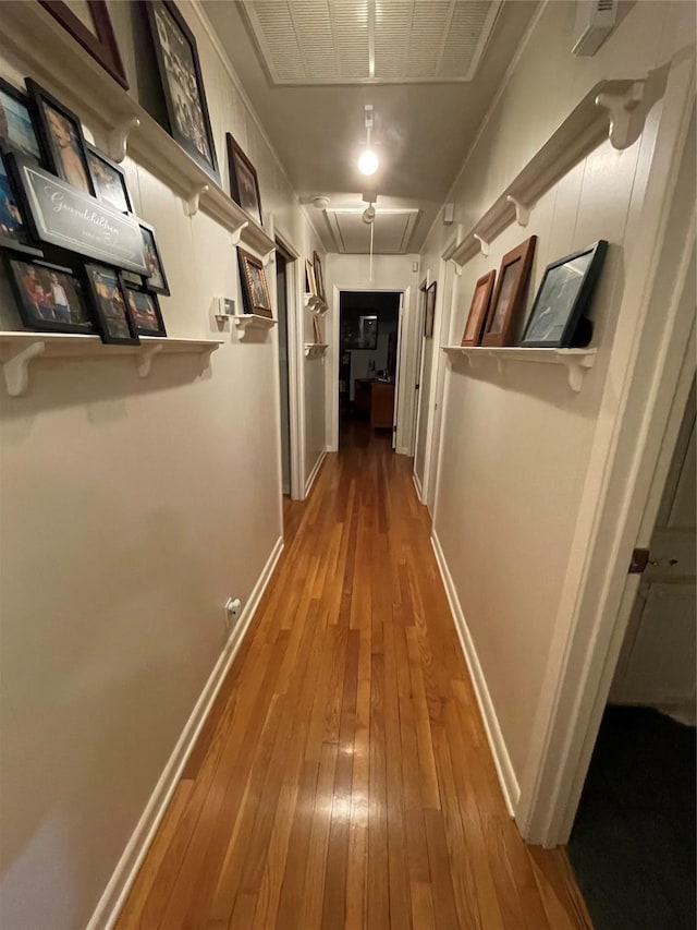 507 Oak Dr, Lake Jackson, TX 77566 - hallway with attic access and hardwood / wood-style flooring