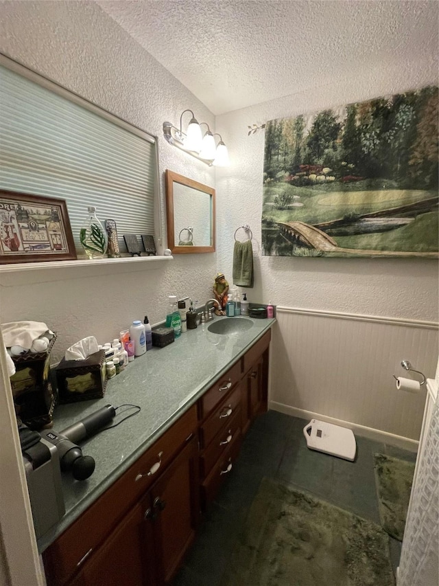 507 Oak Dr, Lake Jackson, TX 77566 - bathroom featuring a textured ceiling, a textured wall, and vanity