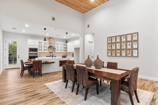 25203 Elijah Ct, Tomball, TX 77375 - dining room with light wood-type flooring, wood ceiling, recessed lighting, and a high ceiling