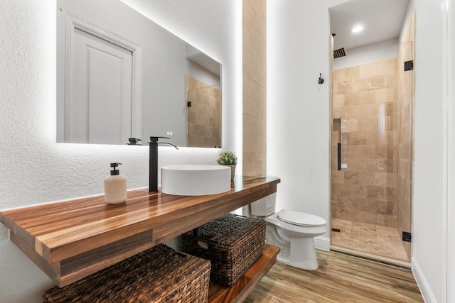 25203 Elijah Ct, Tomball, TX 77375 - full bathroom featuring a stall shower and wood finished floors