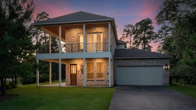 25203 Elijah Ct, Tomball, TX 77375 - view of front of property with a yard, brick siding, driveway, a balcony, and an attached garage