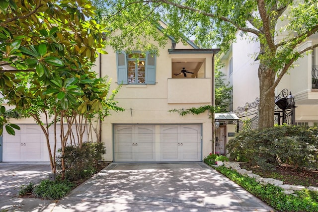 2207 Dunraven Ln, Houston, TX 77019 - view of front of property featuring stucco siding, an attached garage, driveway, and a balcony