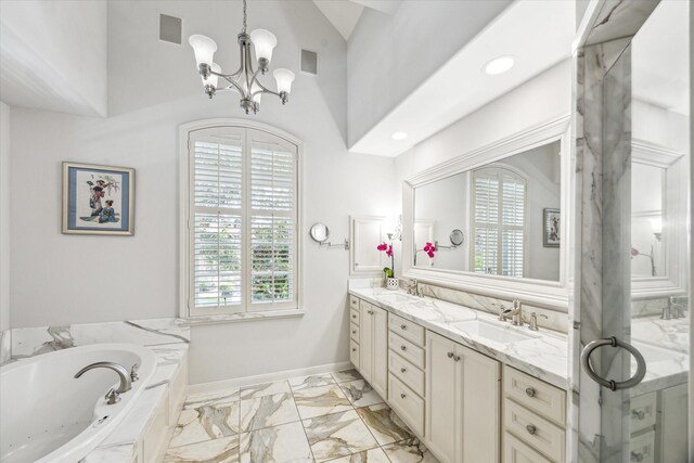 2207 Dunraven Ln, Houston, TX 77019 - bathroom with healthy amount of natural light, marble look tiles, double vanity, and a chandelier