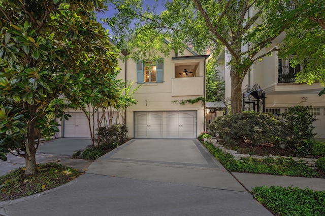 2207 Dunraven Ln, Houston, TX 77019 - view of front facade with stucco siding, an attached garage, and driveway