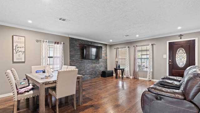 3409 Michigan St, Baytown, TX 77520 - dining room with dark wood-style floors, crown molding, recessed lighting, and a textured ceiling
