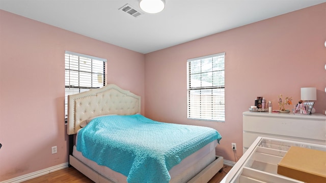 3409 Michigan St, Baytown, TX 77520 - bedroom with multiple windows and wood finished floors