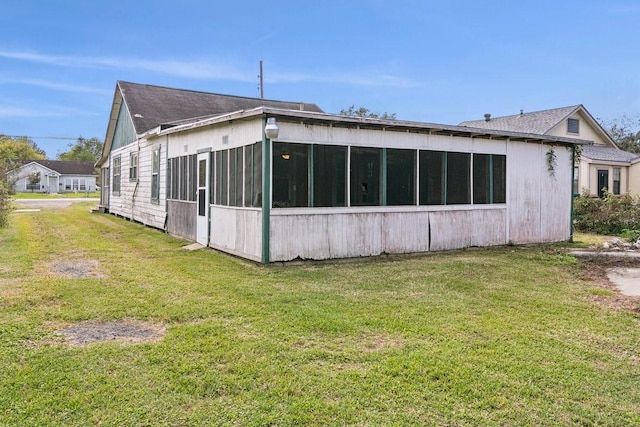 1720 W Highland, Beaumont, TX 77705 - back of house featuring a lawn and a sunroom
