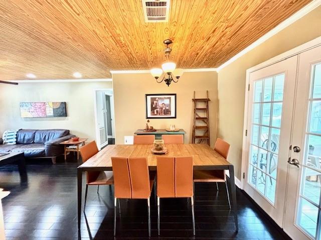 9618 Chatfield St, Houston, TX 77025 - dining space featuring crown molding, wood ceiling, dark wood-style flooring, healthy amount of natural light, and a chandelier