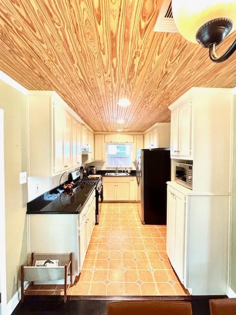 9618 Chatfield St, Houston, TX 77025 - kitchen featuring stainless steel appliances, wood ceiling, dark countertops, and white cabinets