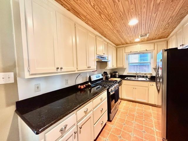 9618 Chatfield St, Houston, TX 77025 - kitchen with appliances with stainless steel finishes, wood ceiling, extractor fan, and white cabinets