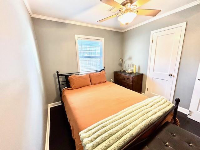 9618 Chatfield St, Houston, TX 77025 - bedroom with crown molding, ceiling fan, and dark wood-type flooring