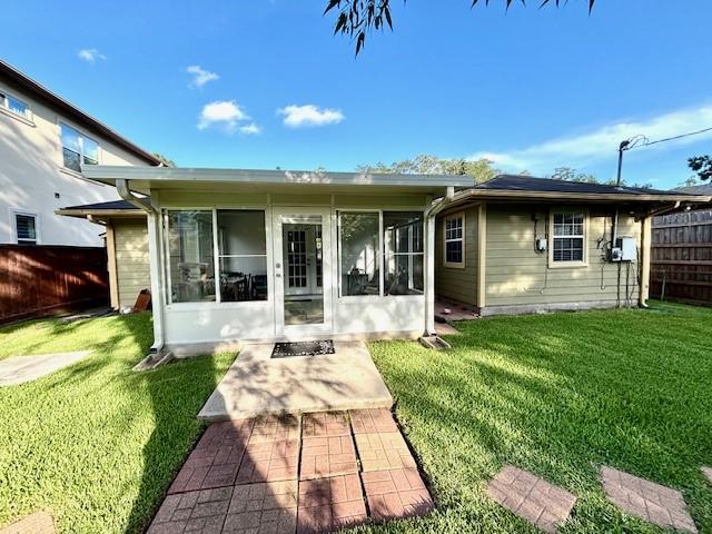 9618 Chatfield St, Houston, TX 77025 - rear view of house featuring a sunroom and a fenced backyard