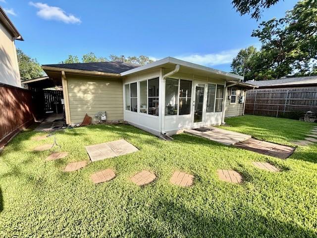 9618 Chatfield St, Houston, TX 77025 - back of house with a sunroom and a fenced backyard