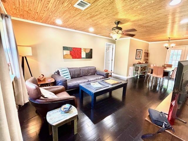 9618 Chatfield St, Houston, TX 77025 - living room with wood ceiling, ornamental molding, dark wood-type flooring, a chandelier, and a ceiling fan