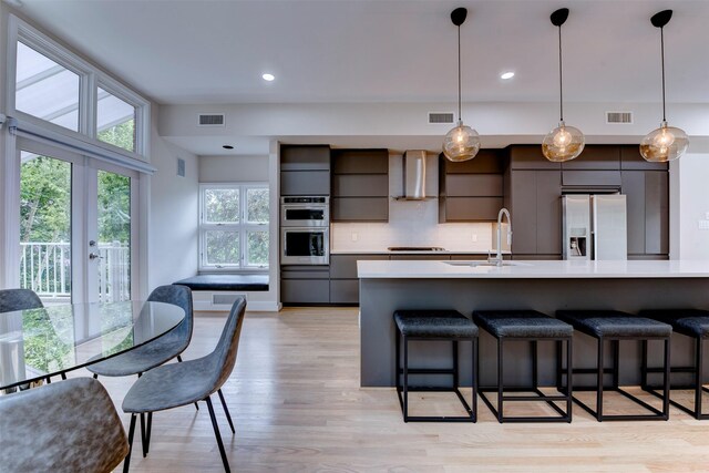 3211 Pittsburg St, West University Place, TX 77005 - kitchen featuring stainless steel appliances, modern cabinets, wall chimney range hood, light countertops, and recessed lighting