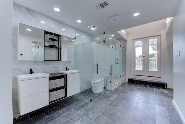 3211 Pittsburg St, West University Place, TX 77005 - bathroom featuring a stall shower, two vanities, and french doors