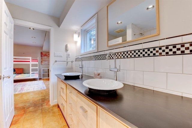 3211 Pittsburg St, West University Place, TX 77005 - bathroom featuring decorative backsplash, double vanity, recessed lighting, and tile patterned flooring