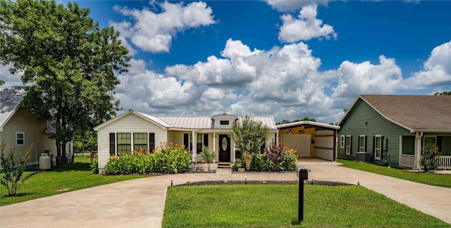 210 N Scott St, Fayetteville, TX 78940 - ranch-style home with driveway, a carport, a front yard, a porch, and a metal roof