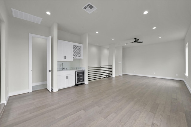 2808 Cary St Unit B, Houston, TX 77003 - unfurnished living room featuring wine cooler, wet bar, light wood-style floors, recessed lighting, and a ceiling fan