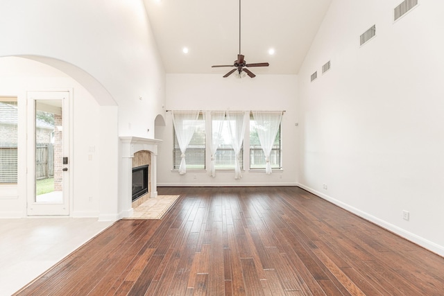19507 Gladewater Ct, Cypress, TX 77433 - unfurnished living room with a ceiling fan, high vaulted ceiling, plenty of natural light, hardwood / wood-style floors, and a high end fireplace