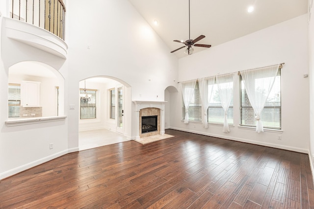 19507 Gladewater Ct, Cypress, TX 77433 - unfurnished living room with a ceiling fan, a tile fireplace, hardwood / wood-style flooring, high vaulted ceiling, and recessed lighting