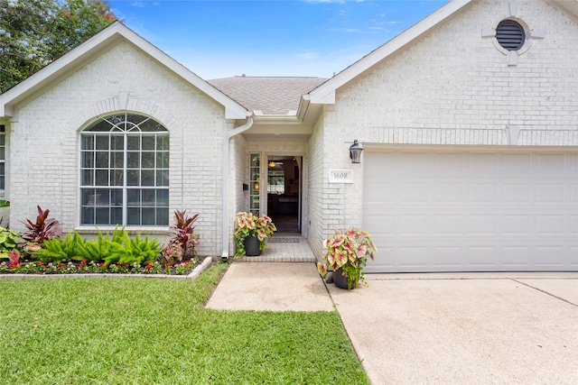 1608 Lark St, Alvin, TX 77511 - view of front of home with brick siding, roof with shingles, a front lawn, an attached garage, and concrete driveway
