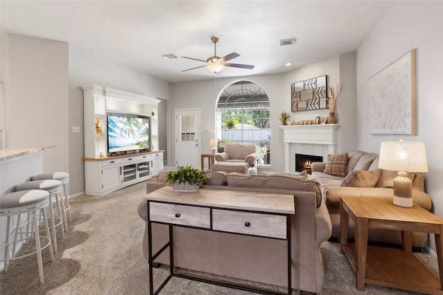 1608 Lark St, Alvin, TX 77511 - living area featuring light carpet, ceiling fan, and a fireplace