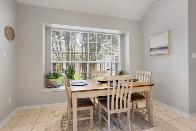 1608 Lark St, Alvin, TX 77511 - dining area featuring light tile patterned flooring and vaulted ceiling