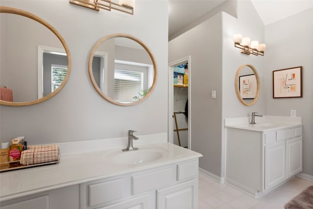 1608 Lark St, Alvin, TX 77511 - bathroom with two vanities and tile patterned floors