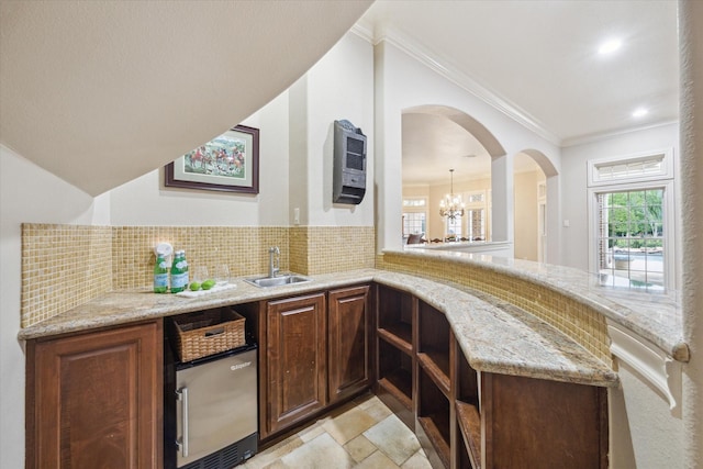 1002 Cowards Creek Ct, Friendswood, TX 77546 - indoor wet bar with backsplash, ornamental molding, a chandelier, and heating unit