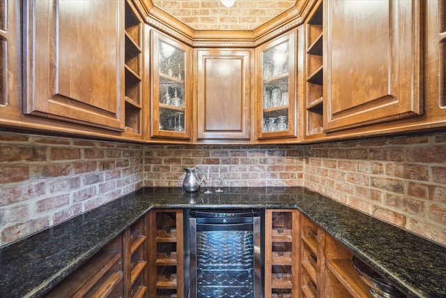 1002 Cowards Creek Ct, Friendswood, TX 77546 - kitchen featuring open shelves, wine cooler, brown cabinetry, and dark stone countertops