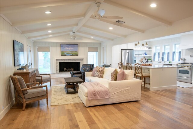7611 Fairdale Ln, Houston, TX 77063 - living area with ceiling fan, light wood-type flooring, a fireplace with raised hearth, and recessed lighting