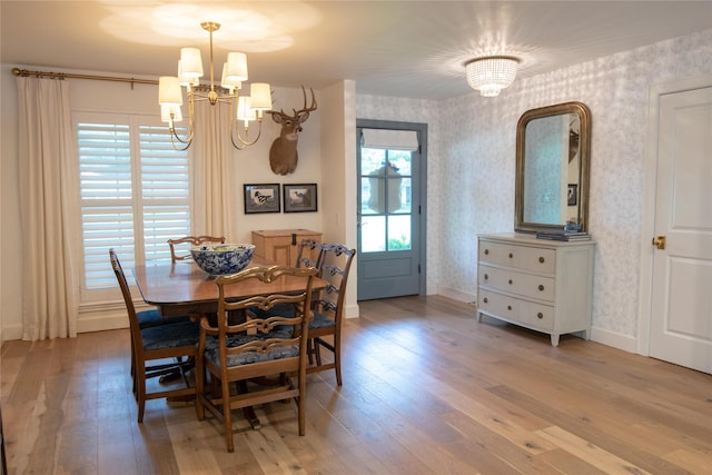 7611 Fairdale Ln, Houston, TX 77063 - dining space with wallpapered walls, a chandelier, and wood-type flooring