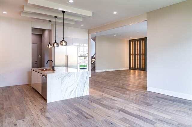 2222 Branard St, Houston, TX 77098 - kitchen featuring modern cabinets, stainless steel appliances, light wood finished floors, decorative light fixtures, and recessed lighting