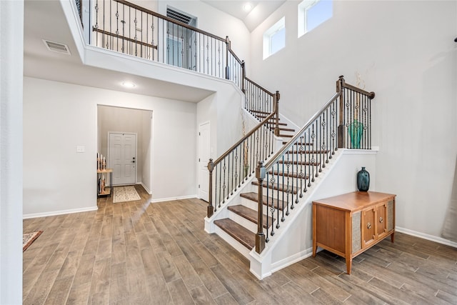 13110 Mid Stocket Dr, Humble, TX 77346 - stairs with a towering ceiling and wood finished floors