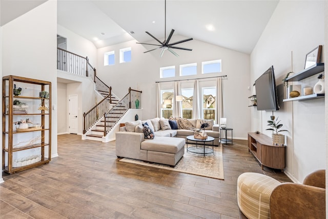 13110 Mid Stocket Dr, Humble, TX 77346 - living room featuring high vaulted ceiling, ceiling fan, wood finished floors, and stairway