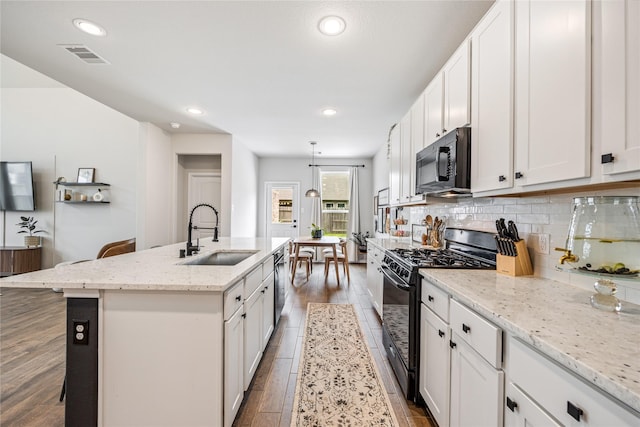 13110 Mid Stocket Dr, Humble, TX 77346 - kitchen featuring black appliances, recessed lighting, a kitchen island with sink, white cabinets, and backsplash