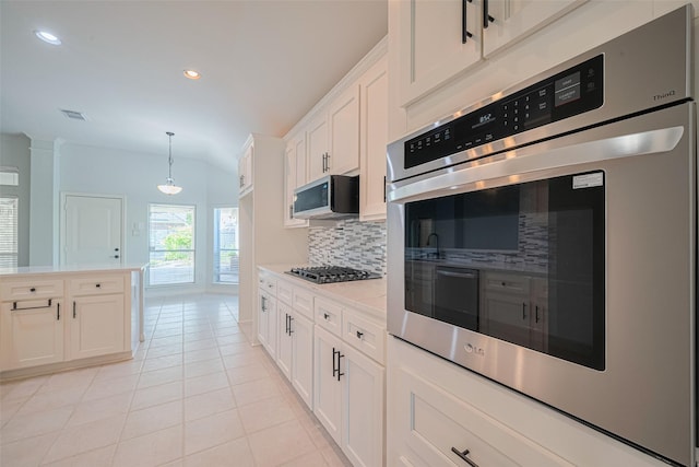 11607 Buck Springs Trl, Tomball, TX 77377 - kitchen with oven, backsplash, light countertops, light tile patterned floors, and white cabinetry