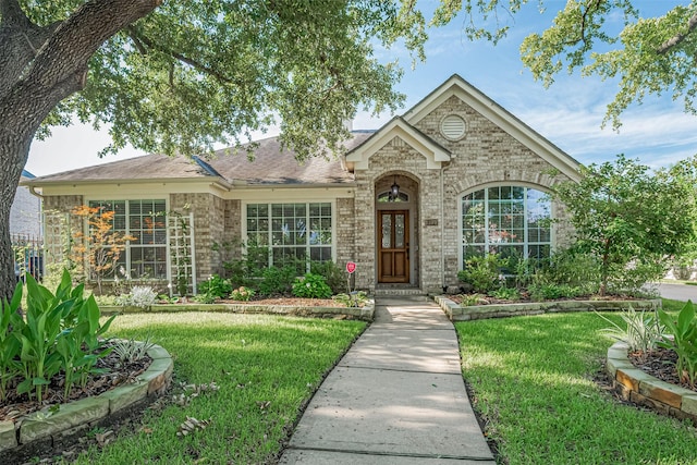 11607 Buck Springs Trl, Tomball, TX 77377 - view of front facade featuring a front lawn, brick siding, and roof with shingles