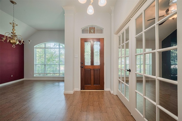 11607 Buck Springs Trl, Tomball, TX 77377 - entrance foyer featuring a chandelier, wood finished floors, french doors, and vaulted ceiling