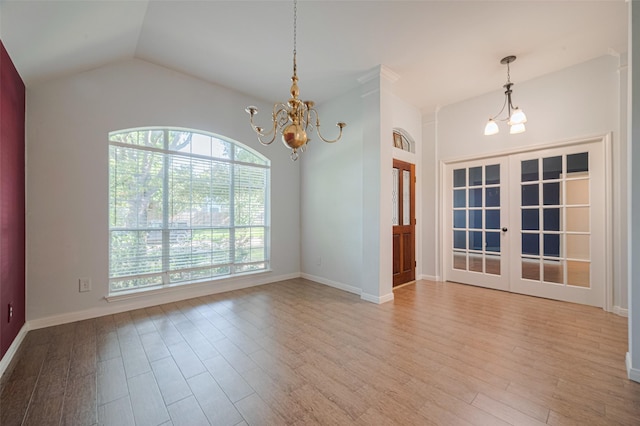 11607 Buck Springs Trl, Tomball, TX 77377 - unfurnished room featuring a chandelier, wood finished floors, lofted ceiling, and french doors
