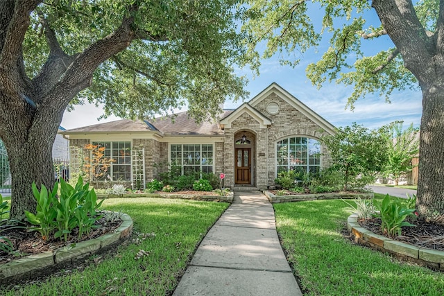 11607 Buck Springs Trl, Tomball, TX 77377 - view of front facade with a front yard and brick siding