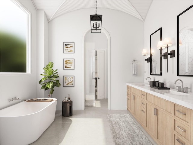 1002 E 25th St, Houston, TX 77009 - full bathroom with double vanity, a freestanding bath, tile patterned floors, and vaulted ceiling