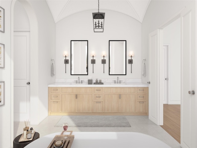 1002 E 25th St, Houston, TX 77009 - bathroom featuring double vanity and vaulted ceiling