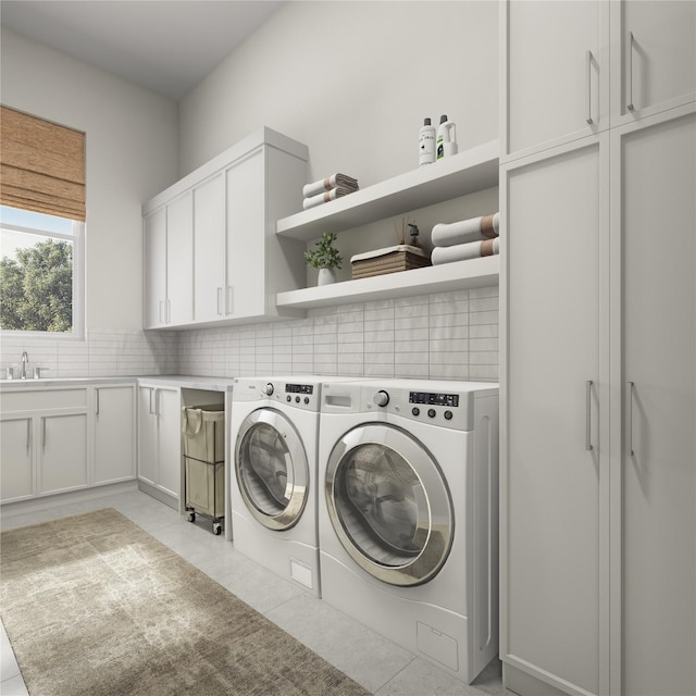 1002 E 25th St, Houston, TX 77009 - laundry area featuring cabinet space, washing machine and clothes dryer, and light tile patterned floors