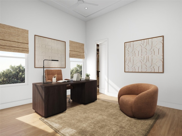 1002 E 25th St, Houston, TX 77009 - home office featuring a ceiling fan, wood finished floors, and a high ceiling