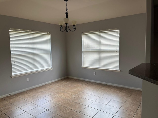 12610 Bethany Bay Dr, Pearland, TX 77584 - unfurnished dining area with tile patterned floors, healthy amount of natural light, and a chandelier