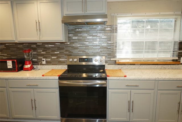 11822 Bandlon Dr, Houston, TX 77072 - kitchen featuring stainless steel range with electric stovetop, exhaust hood, backsplash, and black microwave