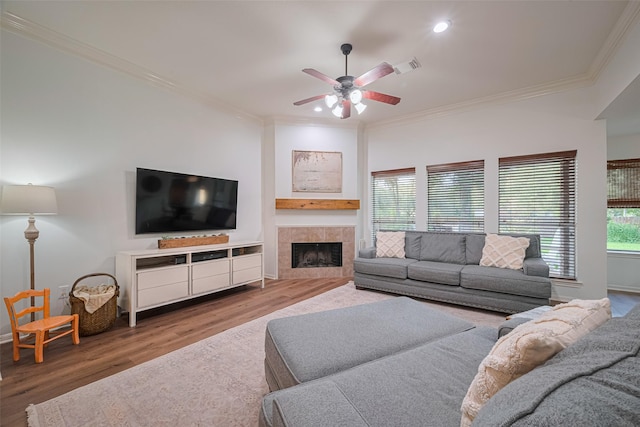 14311 Cally Cir, Needville, TX 77461 - living area featuring ornamental molding, ceiling fan, wood finished floors, a fireplace, and recessed lighting