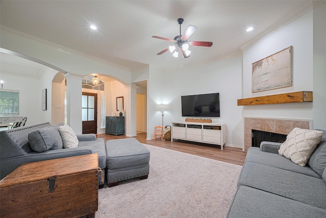 14311 Cally Cir, Needville, TX 77461 - living room featuring ornate columns, arched walkways, wood finished floors, a ceiling fan, and crown molding